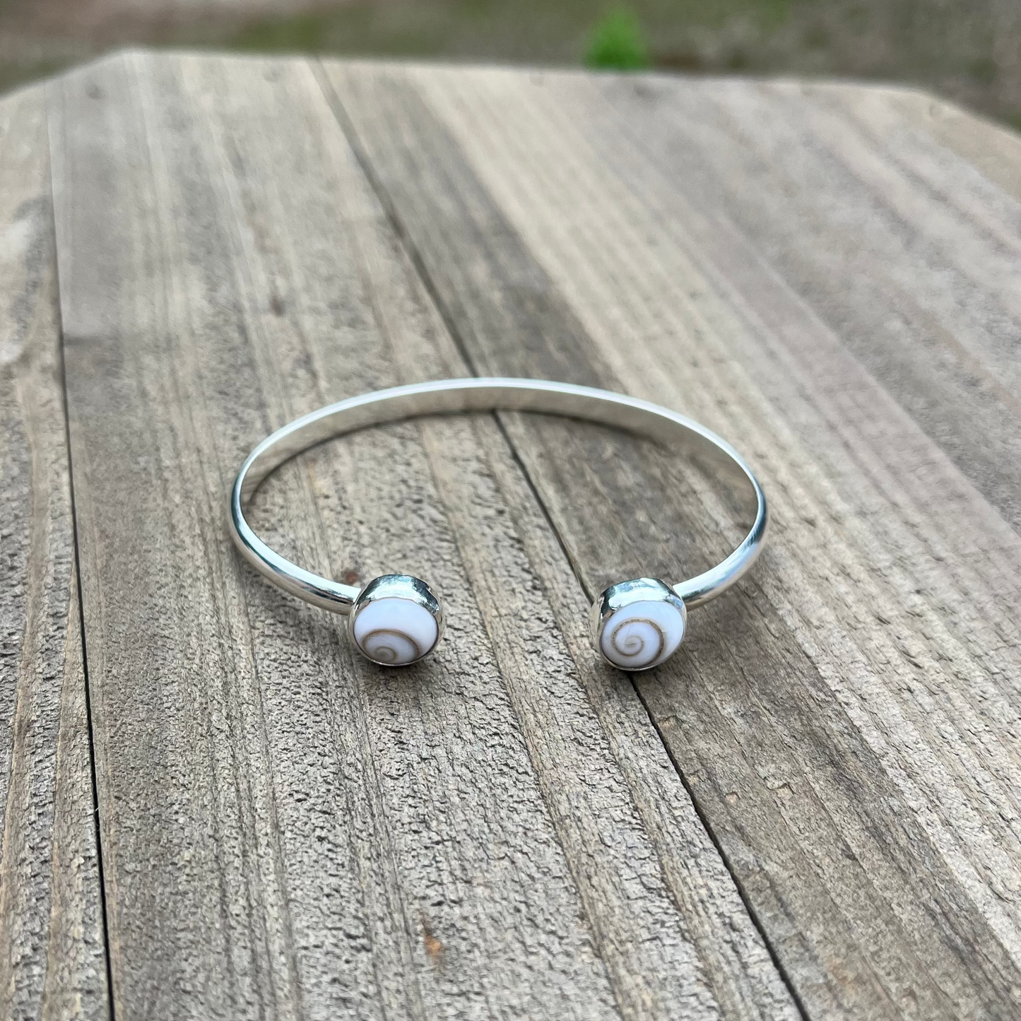 handcrafted sterling silver cuff bracelet with shiva shell cabochons by Ocean love designs