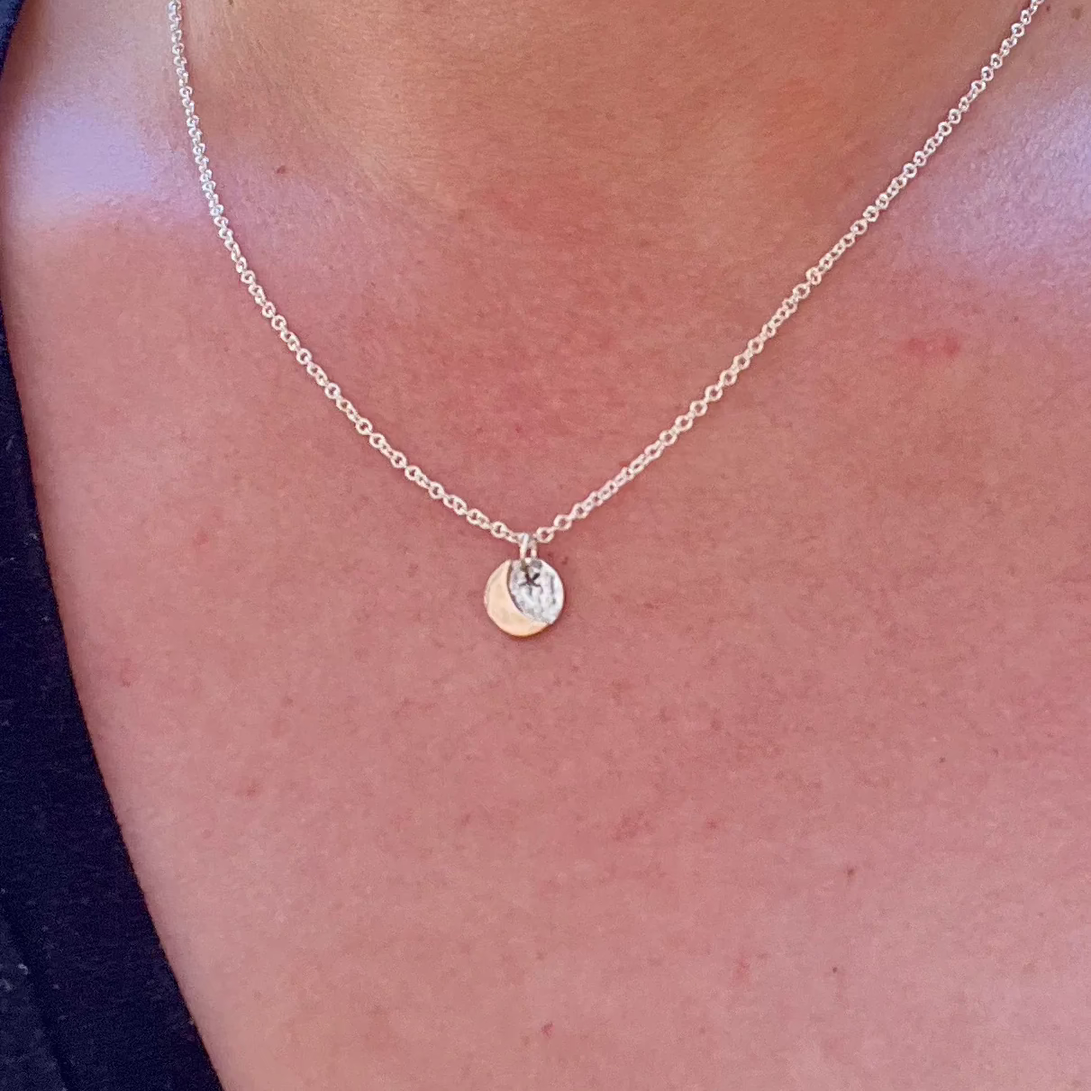 Tiny gold moon on silver back