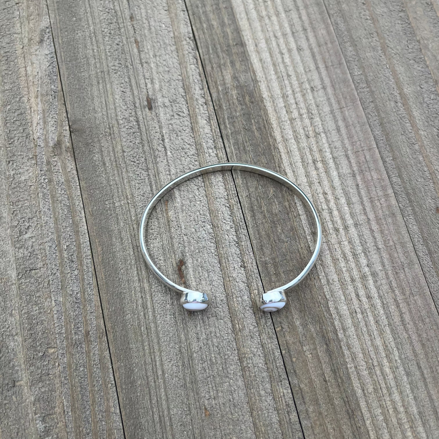 handcrafted sterling silver cuff bracelet with shiva shell cabochons by Ocean love designs