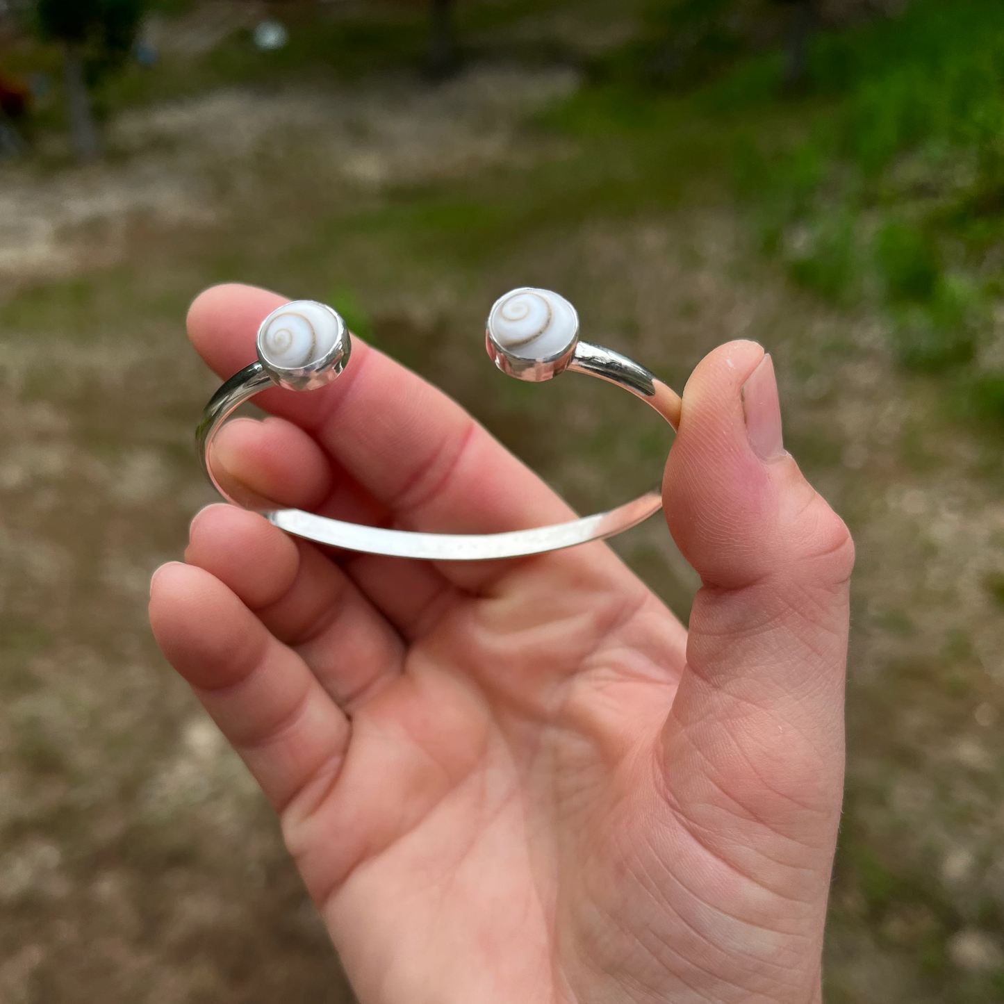 handcrafted sterling silver cuff bracelet with shiva shell cabochons by Ocean love designs