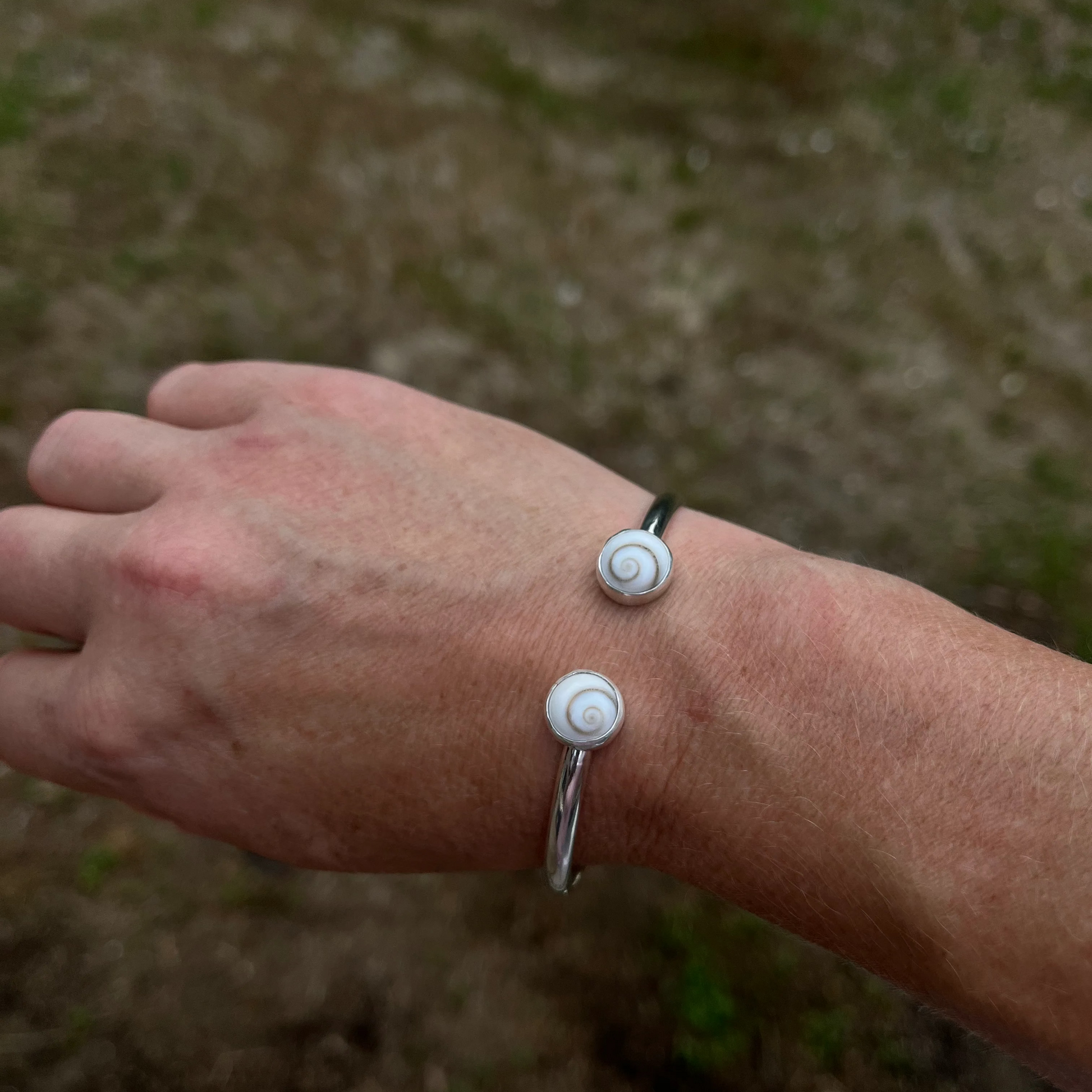 handcrafted sterling silver cuff bracelet with shiva shell cabochons by Ocean love designs
