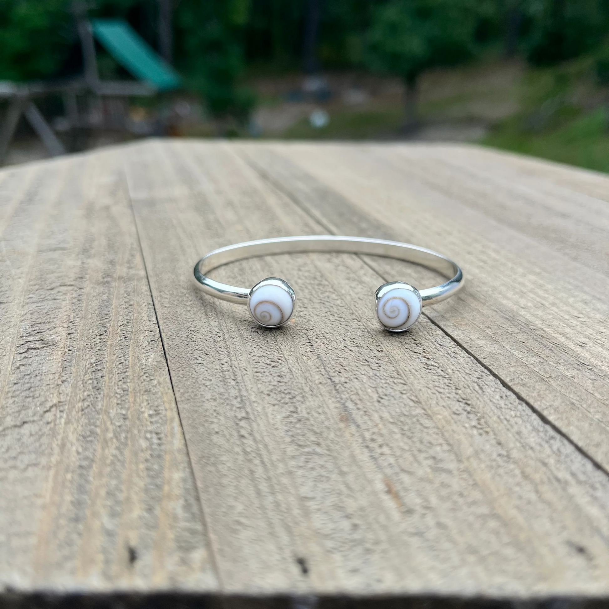 handcrafted sterling silver cuff bracelet with shiva shell cabochons by Ocean love designs