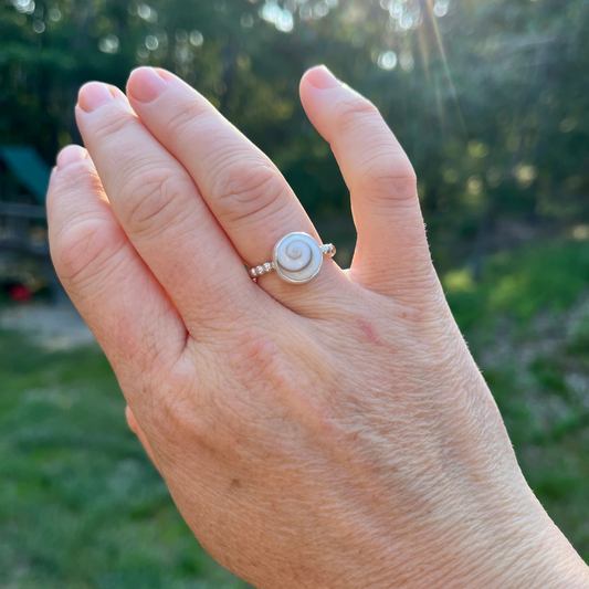 Beaded sterling silver band set with a Shiva Shell cabochon